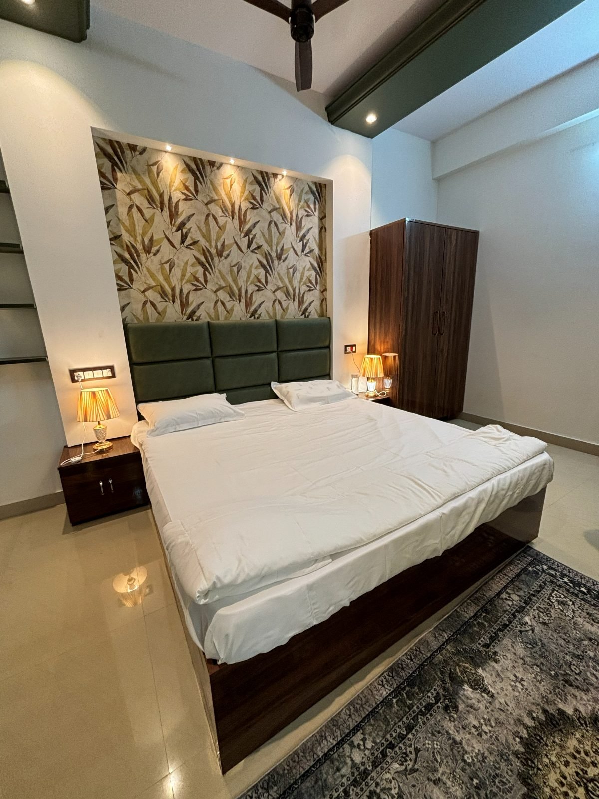 King bedroom with a tufted green headboard