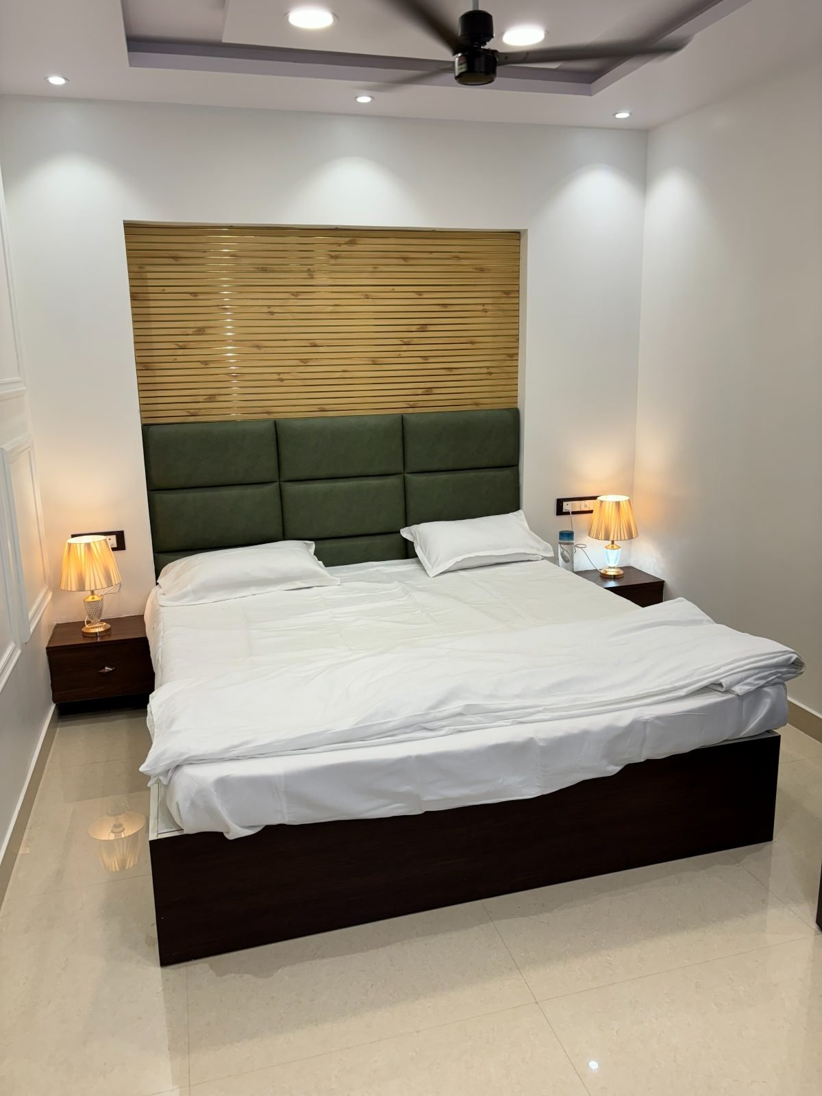Bedroom framed by a warm wood-slat wall